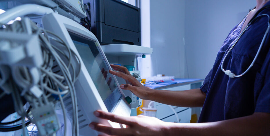 Surgeon using medical equipment in operating room of the hospital