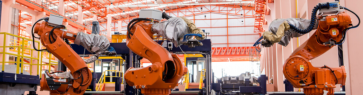 Robots welding in a production line