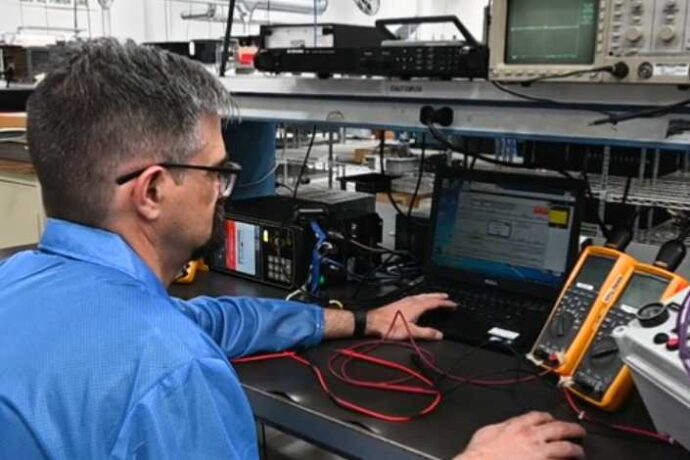 PGF employee using in-circuit testing on PCBA